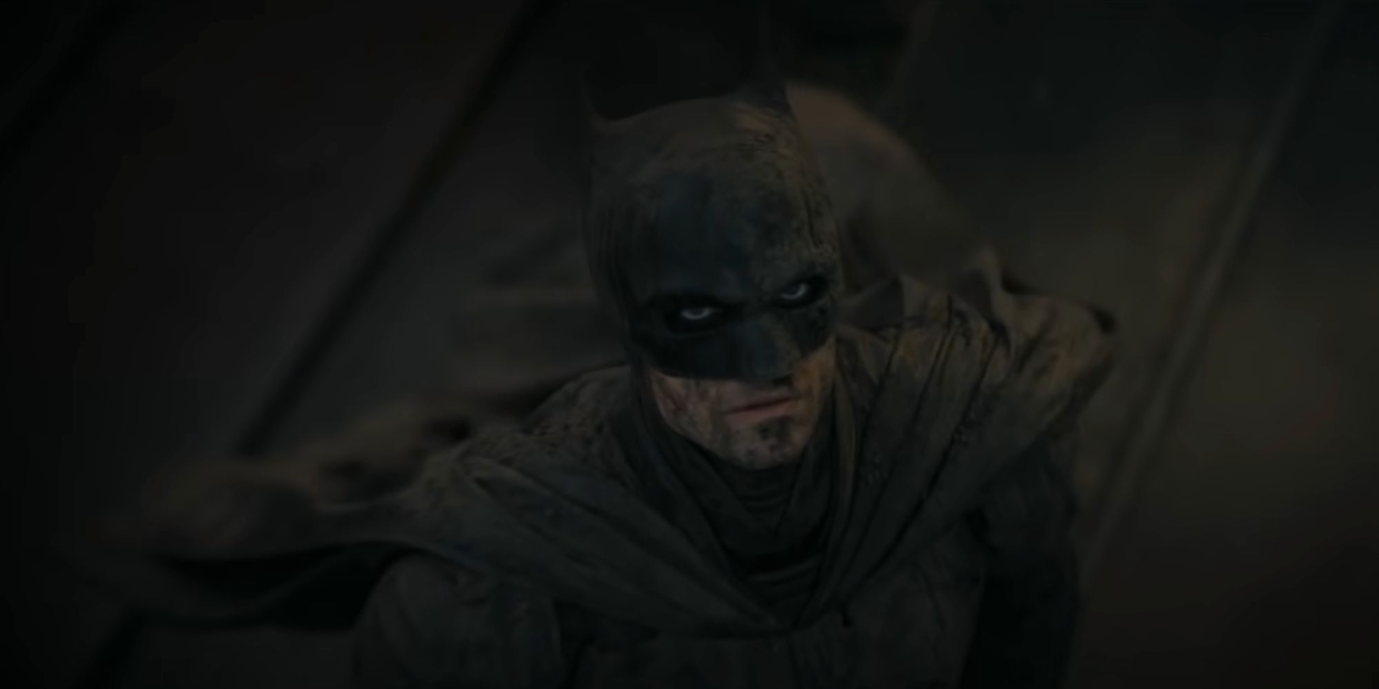 Batman watching a civilian being rescued in The Batman